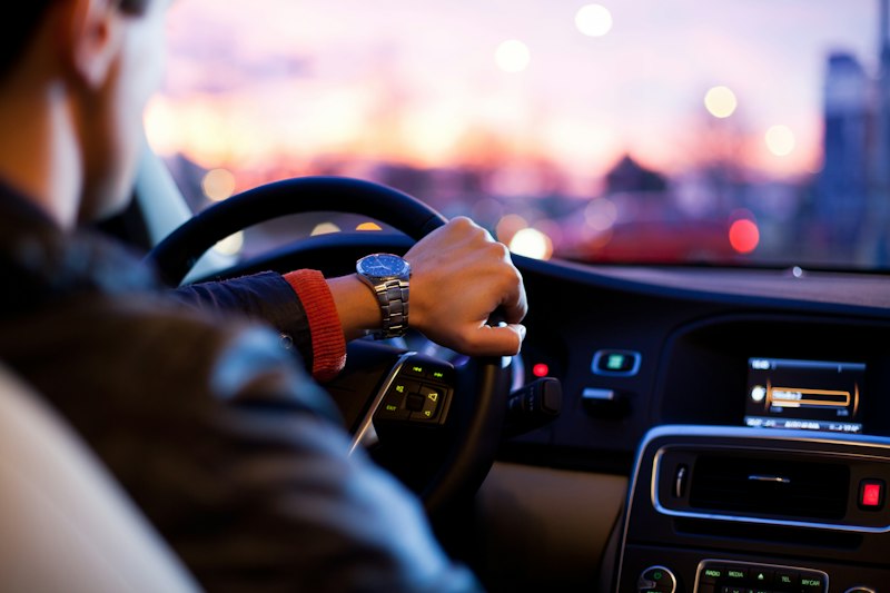 Driver behind vehicle steering wheel evaluating coverage